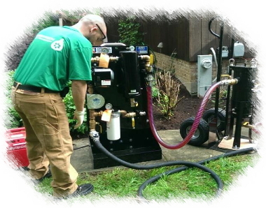 Photograph of a Greentech employee using a fuel cleaning machine.